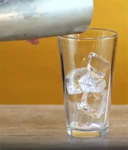 Fill a tall highball glass to the top with ice cubes