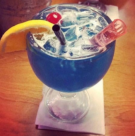 Overhead view of Texas Roadhouse's signature Blue Crush Lemonade cocktail with lemon and lime slices