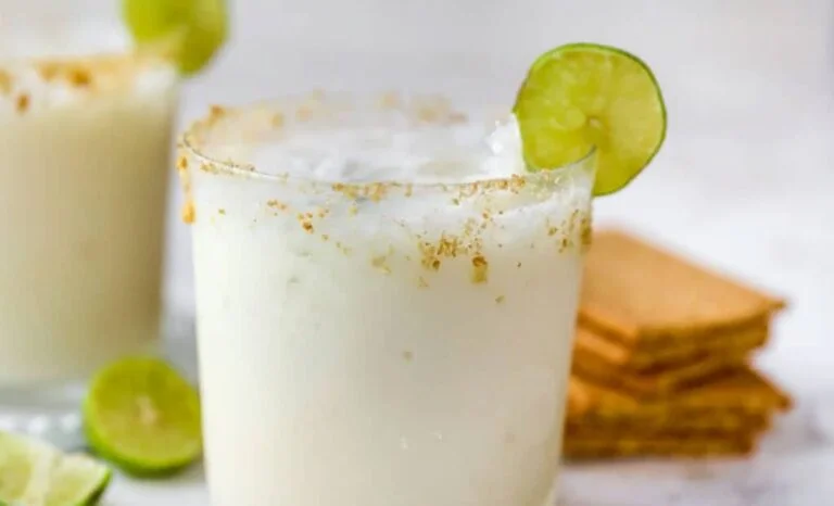 Close up of a key lime margarita cocktail with salt rim in a margarita glass