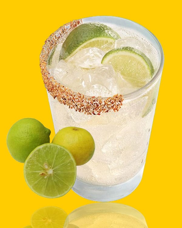 Texas roadhouse cactus water cocktail served with Mexican food like tacos and queso dip on decorative skulls and cactus decor plates