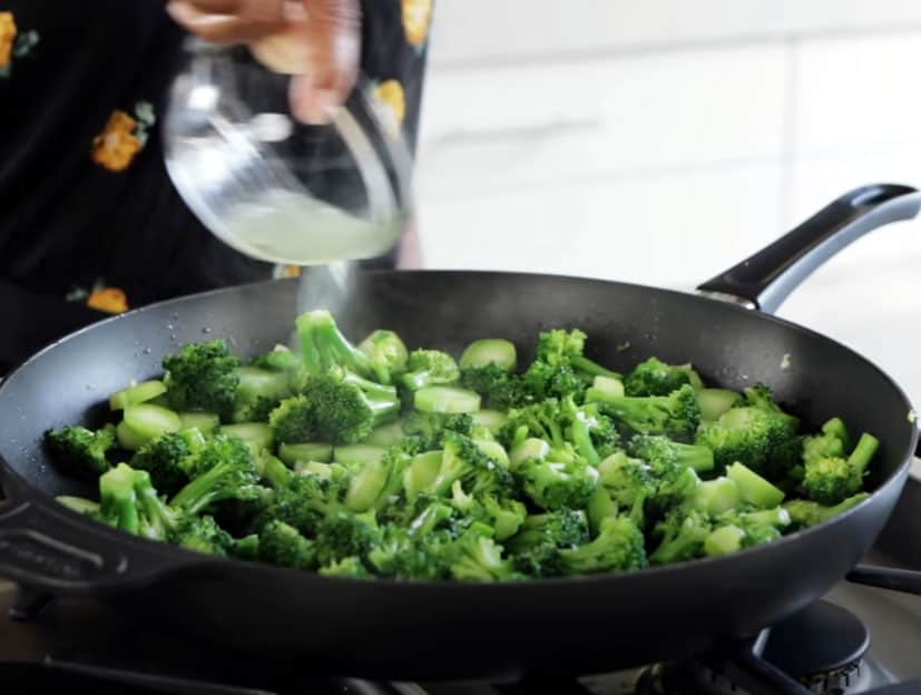 broccoli florets cooking in skillet