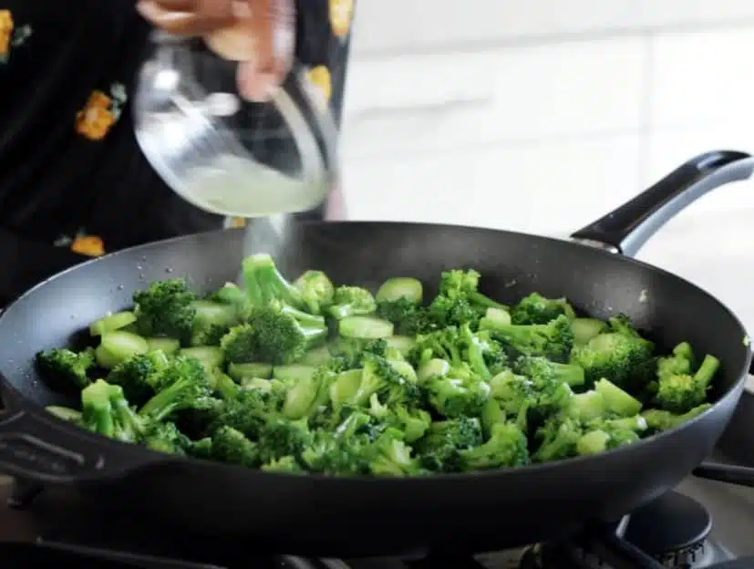 broccoli florets cooking in skillet