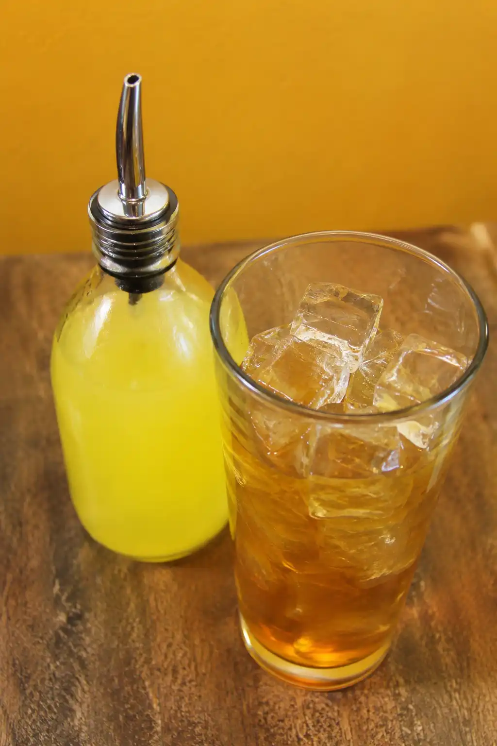 Whiskey and sour mix shaking in a cocktail shaker with ice